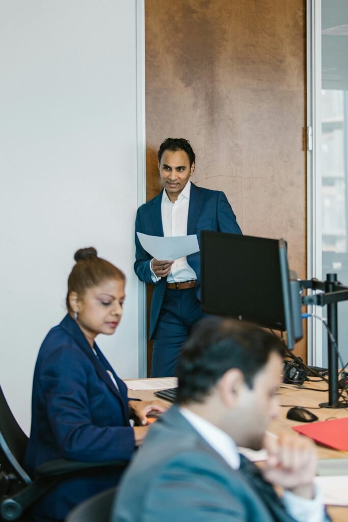 Business professionals collaborating in a modern office setting, focused on team success.